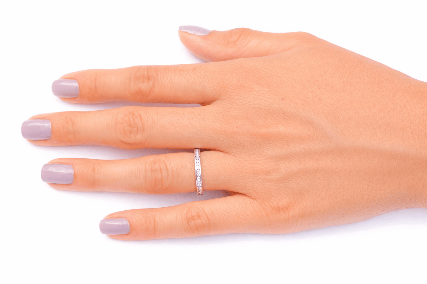 Hand wearing a diamond ring on a white background