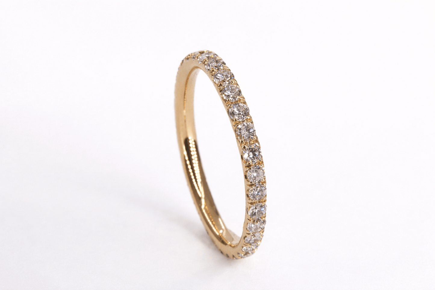 Gold ring with diamonds on a white background