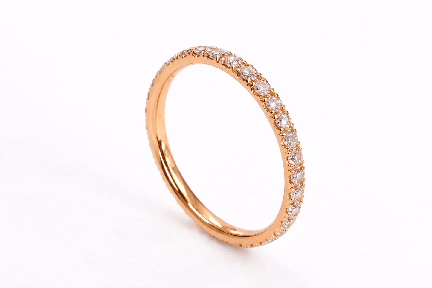 Rose gold ring with diamonds on a white background