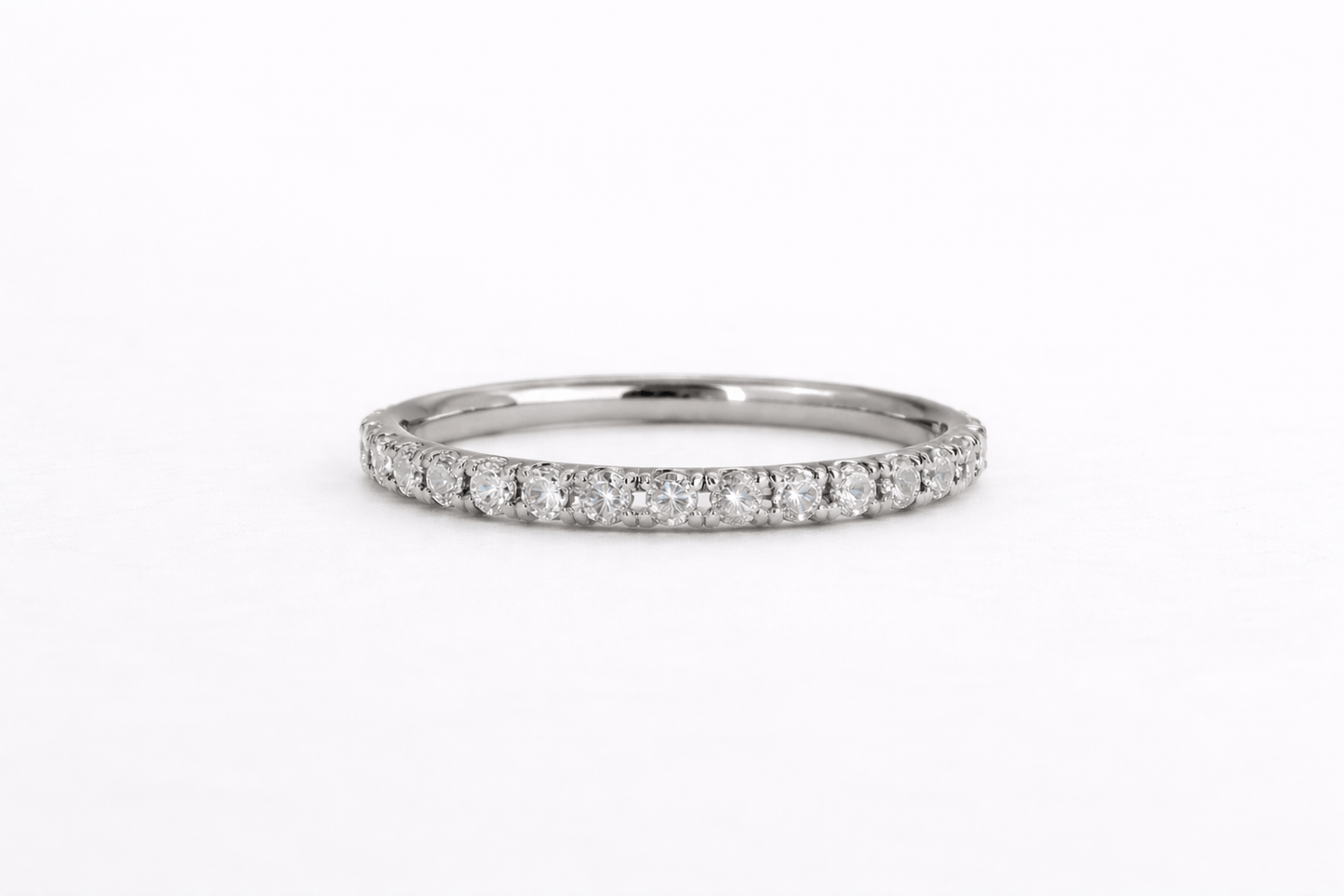 Silver ring with small diamonds on a white background