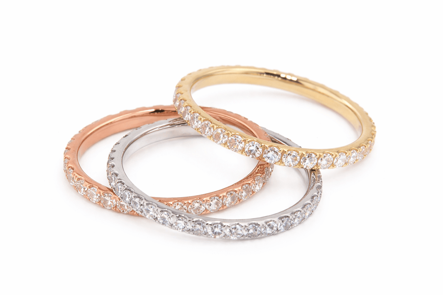 Three gold, rose gold, and silver rings with diamond accents on a white background