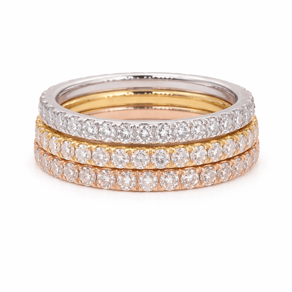 Three diamond-studded rings stacked on a white background