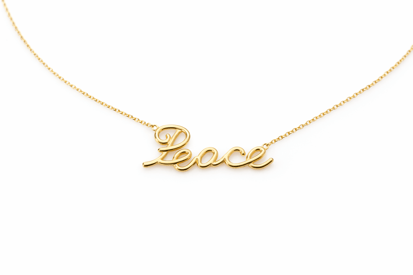Gold necklace with 'Peace' pendant on a white background