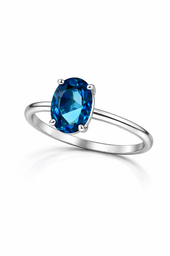 Silver ring with a blue gemstone on a white background