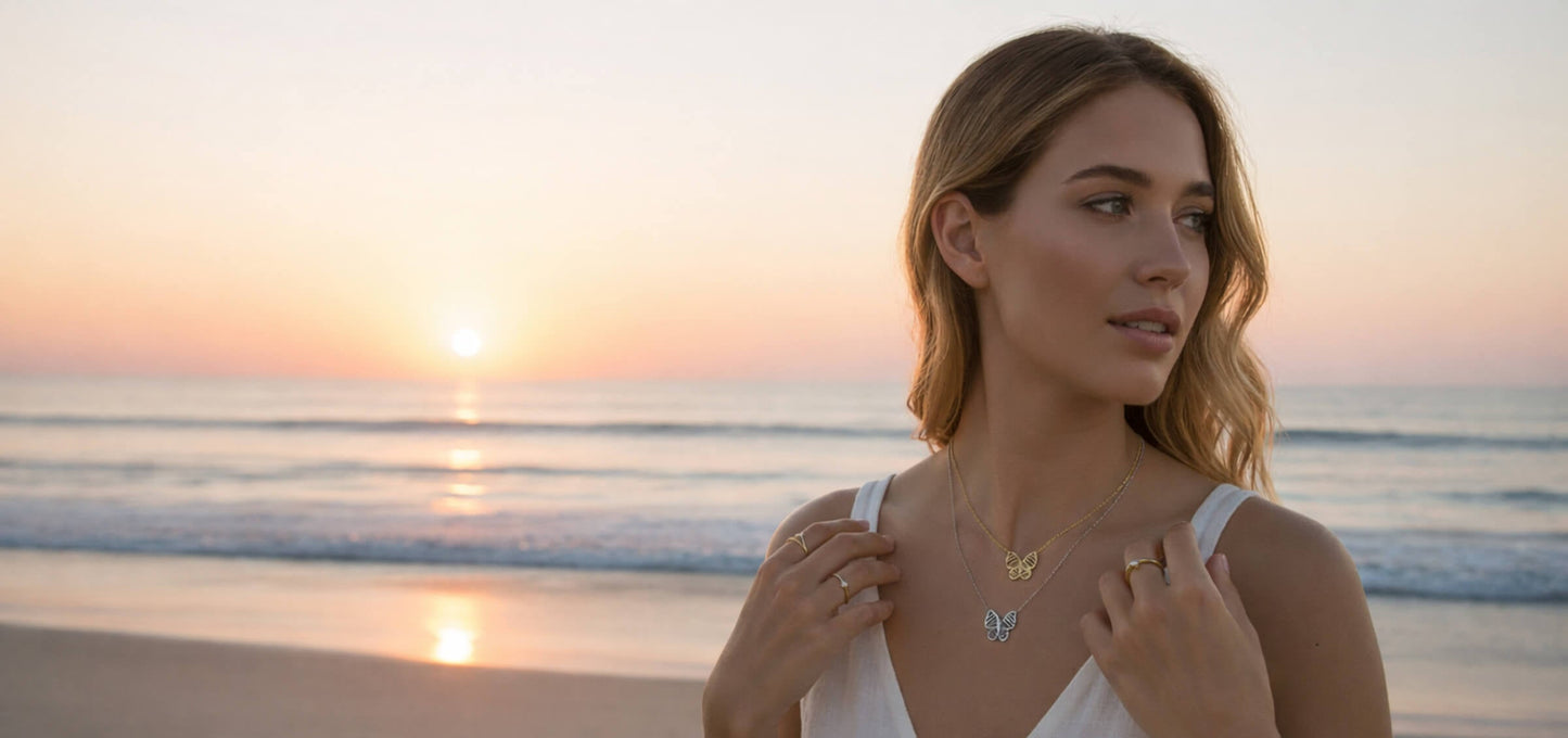 Woman in a white dress standing on a beach at sunset