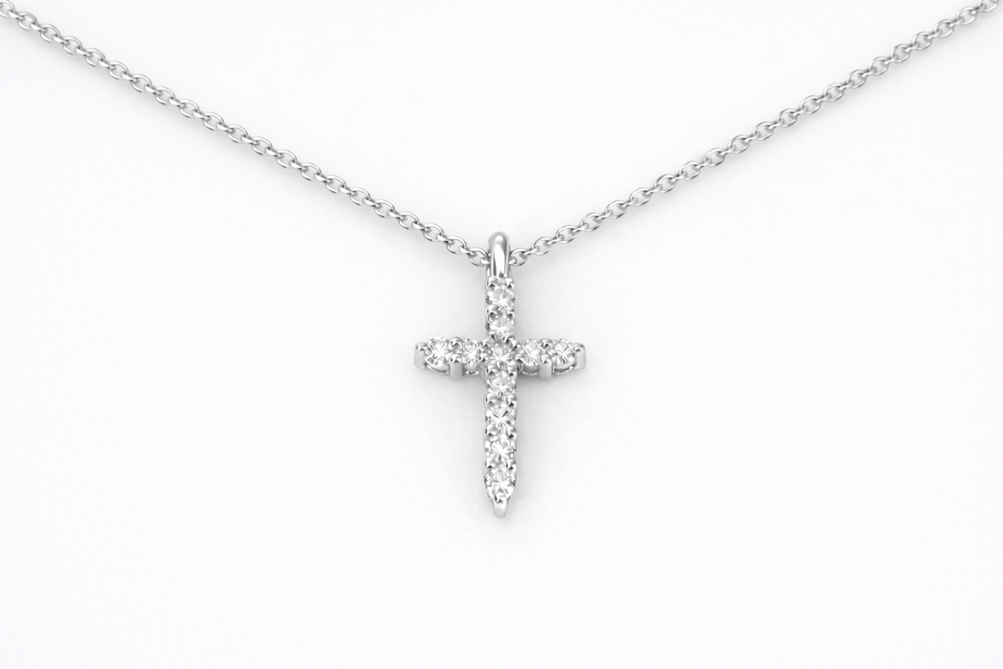 Silver cross necklace on a white background
