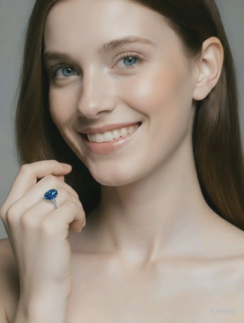 Model wearing 14k white gold blue topaz engagement ring 
