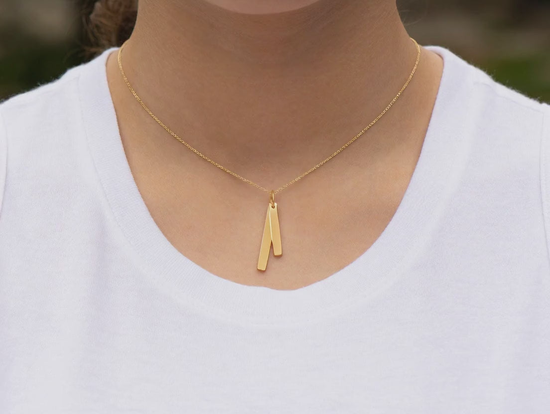 short video of a model wearing a 14k double bar necklace in yellow gold